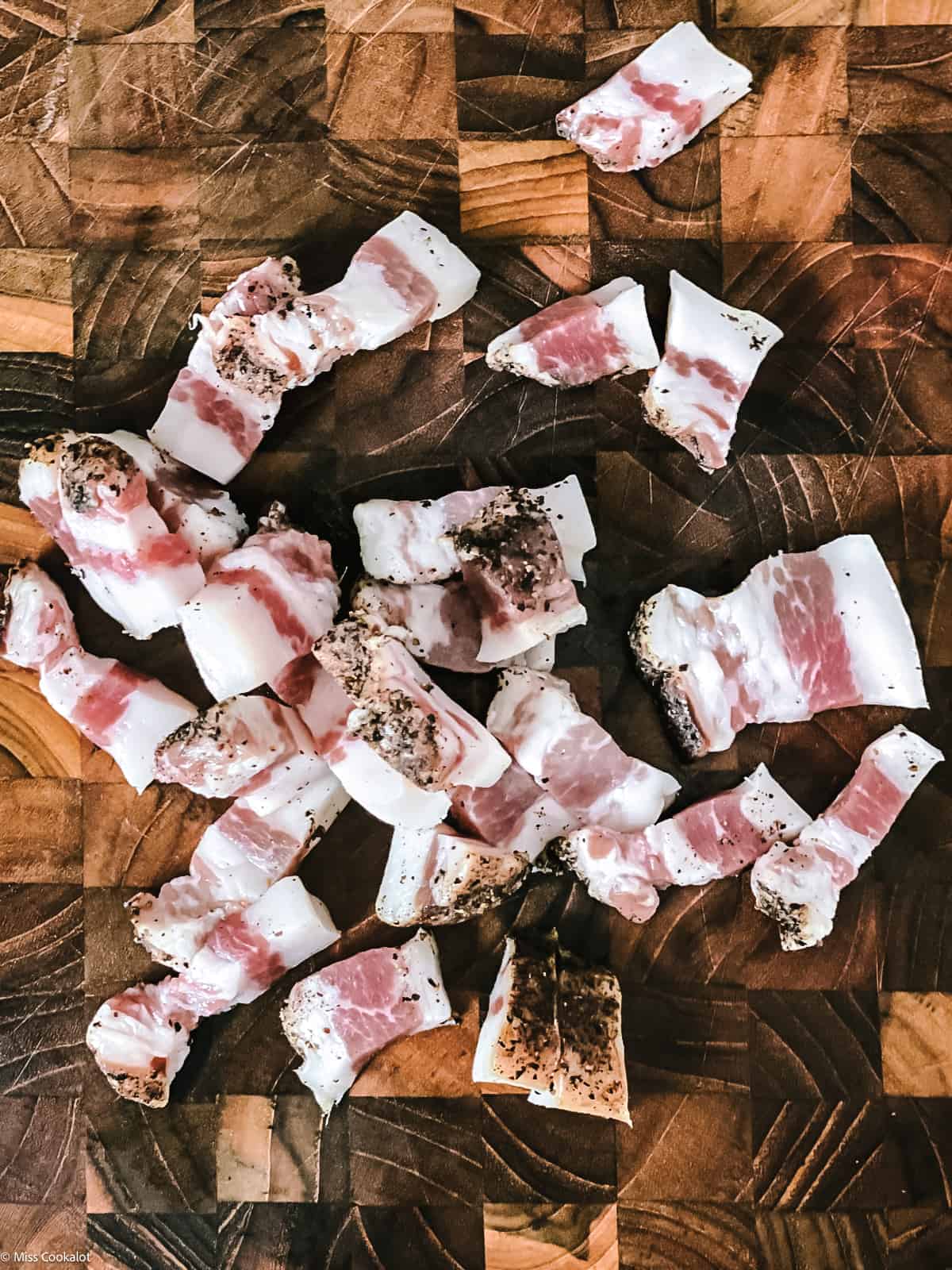 Gunchiale cut in bite size pieces on a butcher block.
