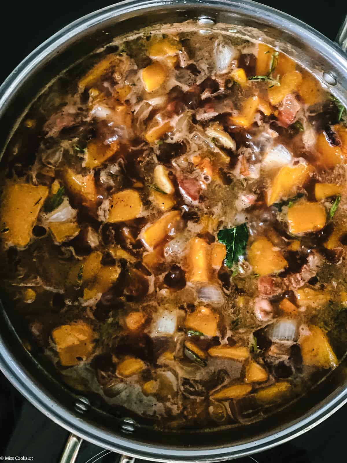 Pumpkin cubes and guanciale pieces
chopped onion and garlic in broth in a deep sauce pan.